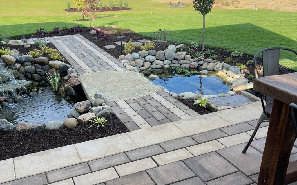 Backyard landscaped with pavers and ponds